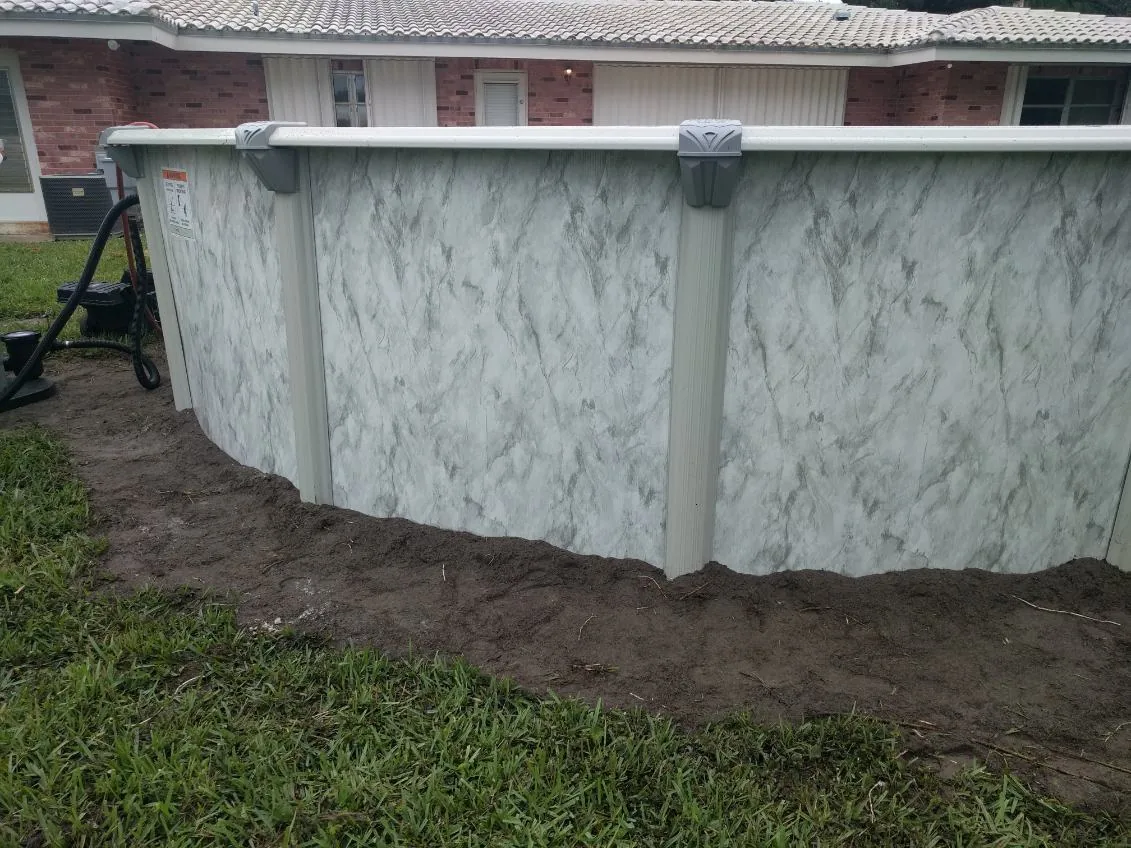 Close view of an aboveground pool wall panel and top rail