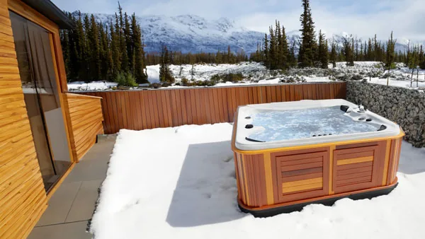 Arctic Spas Kodiak installed on an outdoor patio beside seating