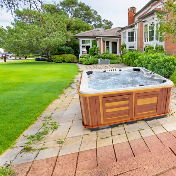 Arctic Spas Summit seven-seat hot tub steaming gently on a wooden deck