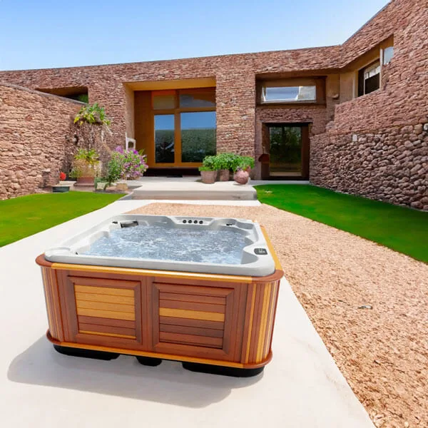 Arctic Spas Totem hot tub with deep upright seats beside a modern pool