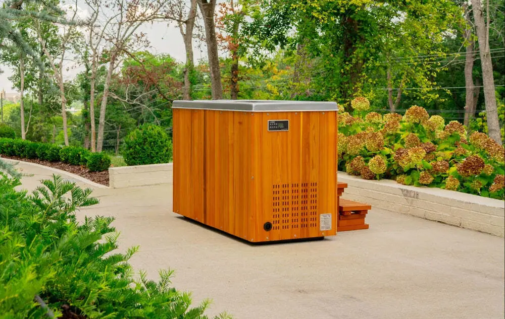 Icepod cold plunge tub with timber-look cladding beside a modern pool