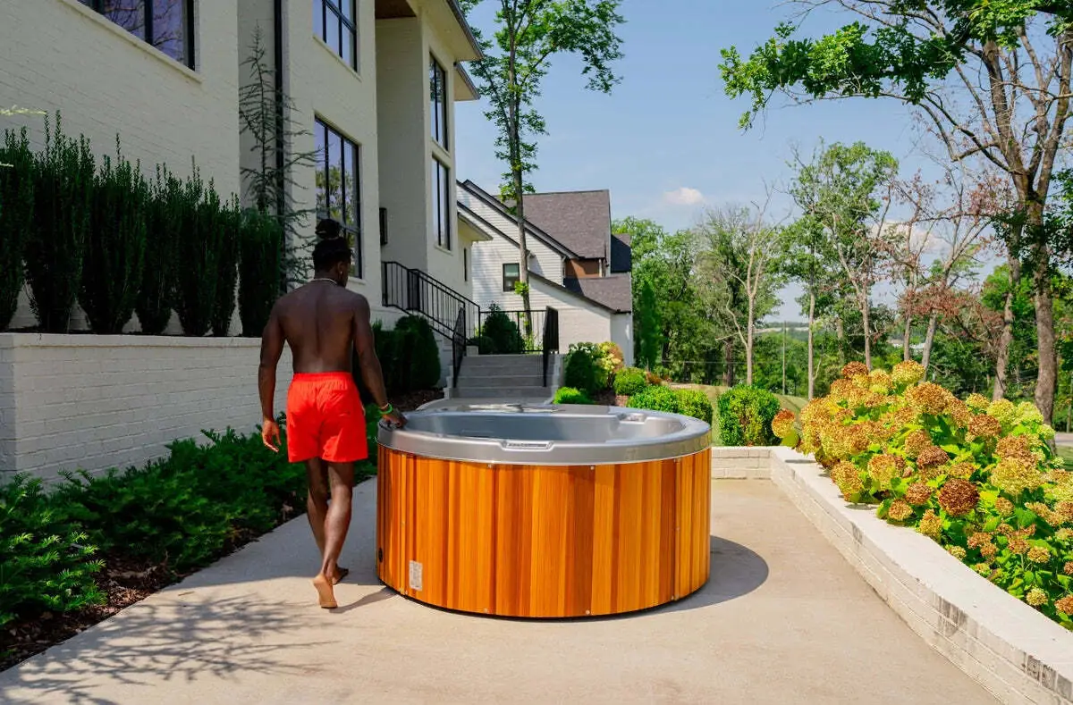 Polarpool cold water pool with bathers beside a garden wall