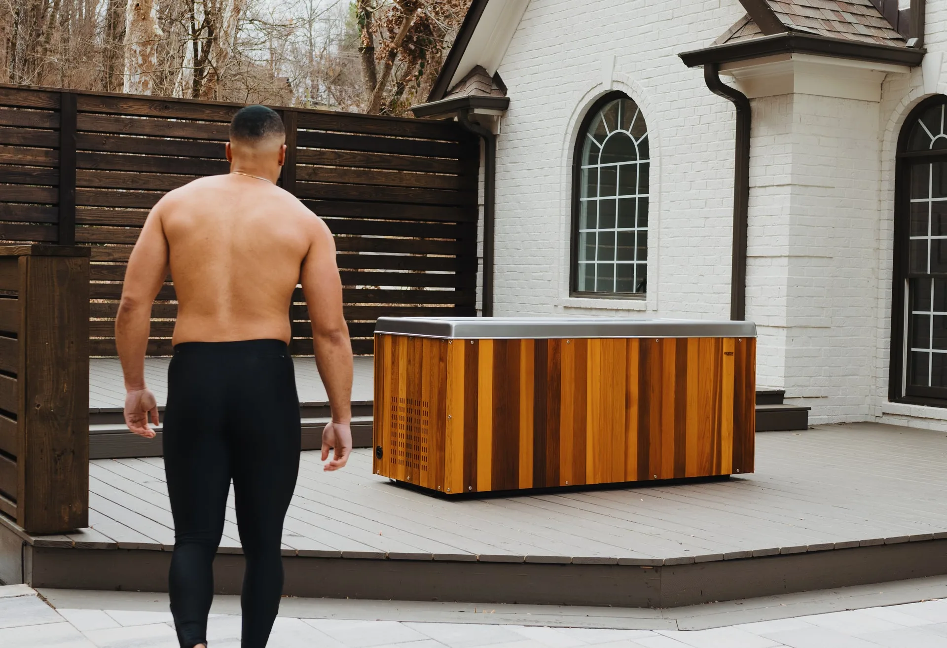 The Coldtub residential cold immersion tub beside a spa in a garden