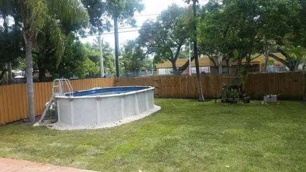 Compact round aboveground pool in a fenced Florida backyard