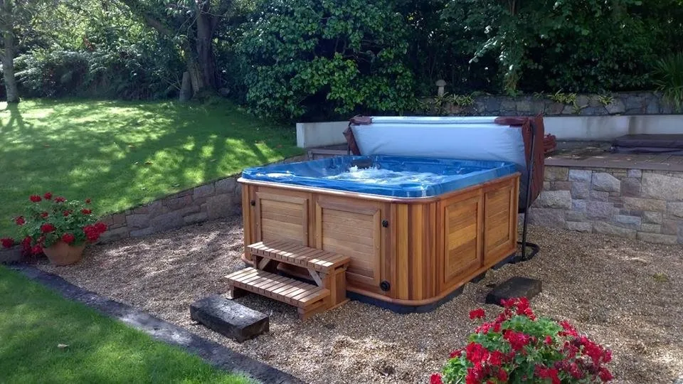 Cold plunge tub set into a lush North Miami garden beneath a timber pergola