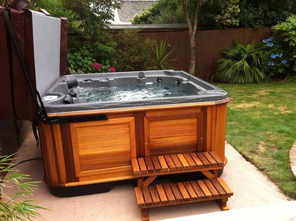 Premium hot tub beside a pool on a tidy deck at a Weston-area home