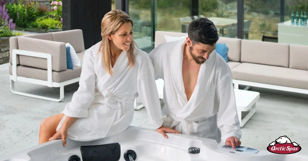 Spa specialist reviewing hot tub options with a customer in a bright showroom