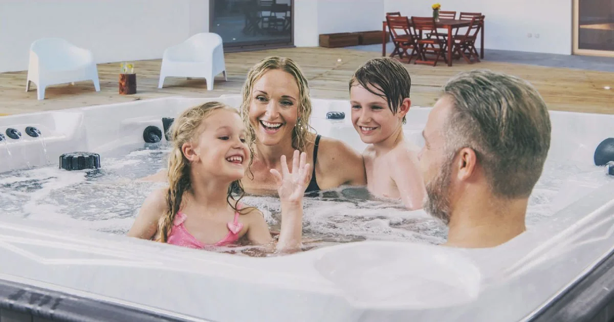 Spa specialist explaining hot tub features to customers in the showroom