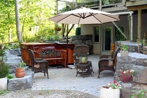 Evening backyard spa terrace lit with warm lighting