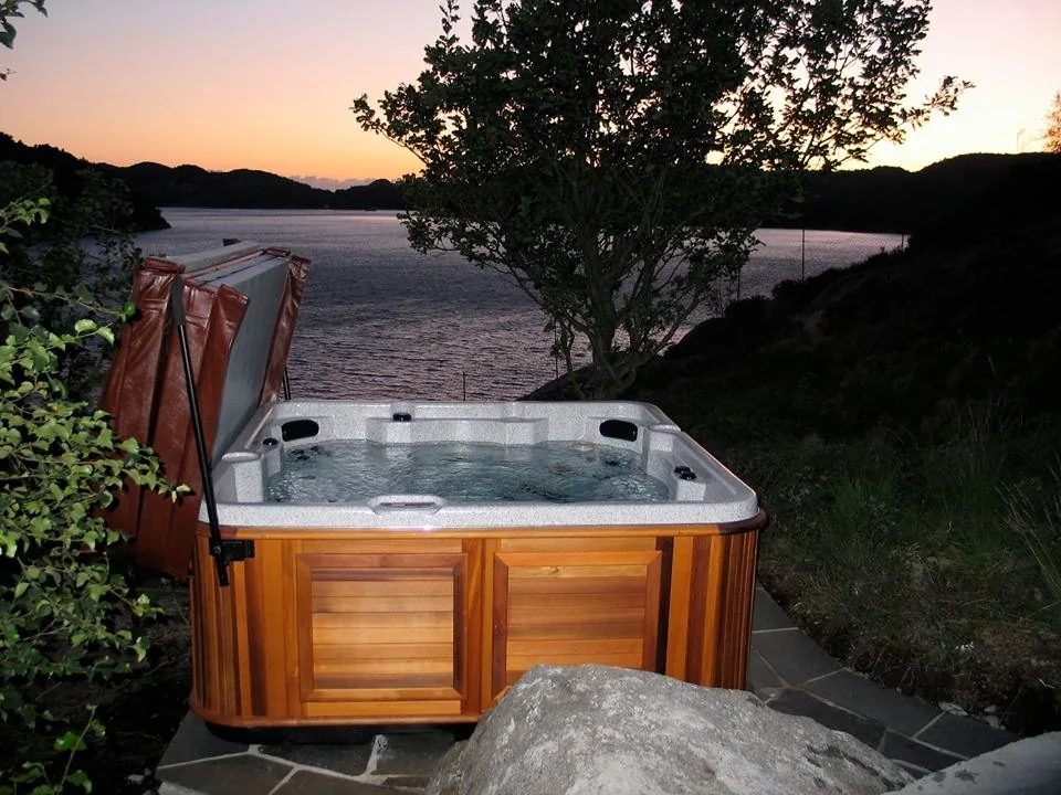 Luxury hot tub glowing at sunset in a South Florida backyard