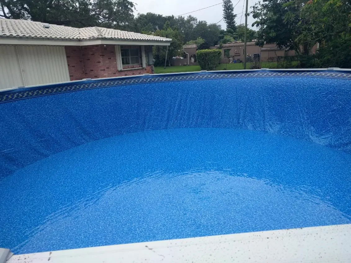 Round aboveground pool with a blue patterned liner in a Florida backyard